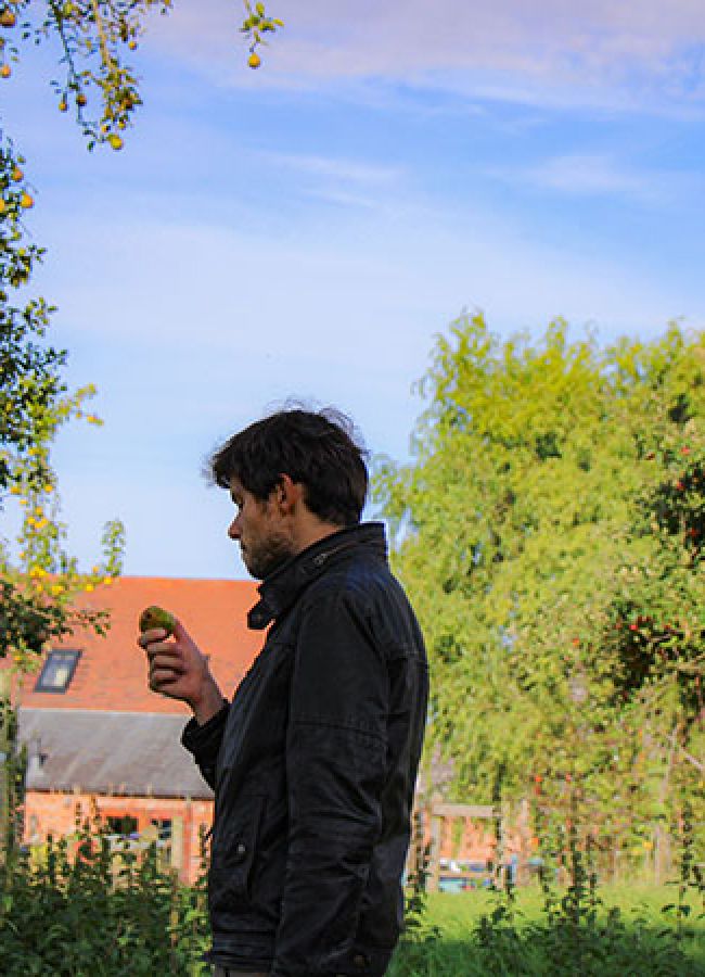 Photo of Adam Wells in an orchard
