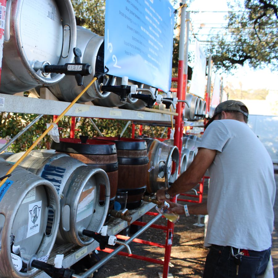 Photo of a man pouring a pint of cask beer from a rack © 2024, Justin Brummer