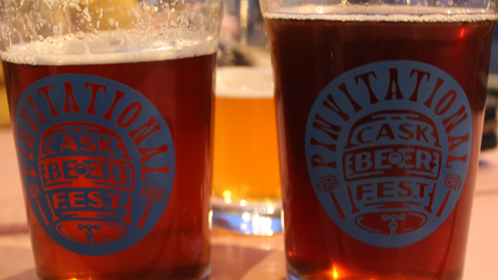 Close up of two pints of cask beer, with the pinvitational branding logo on the side © 2024, Justin Brummer