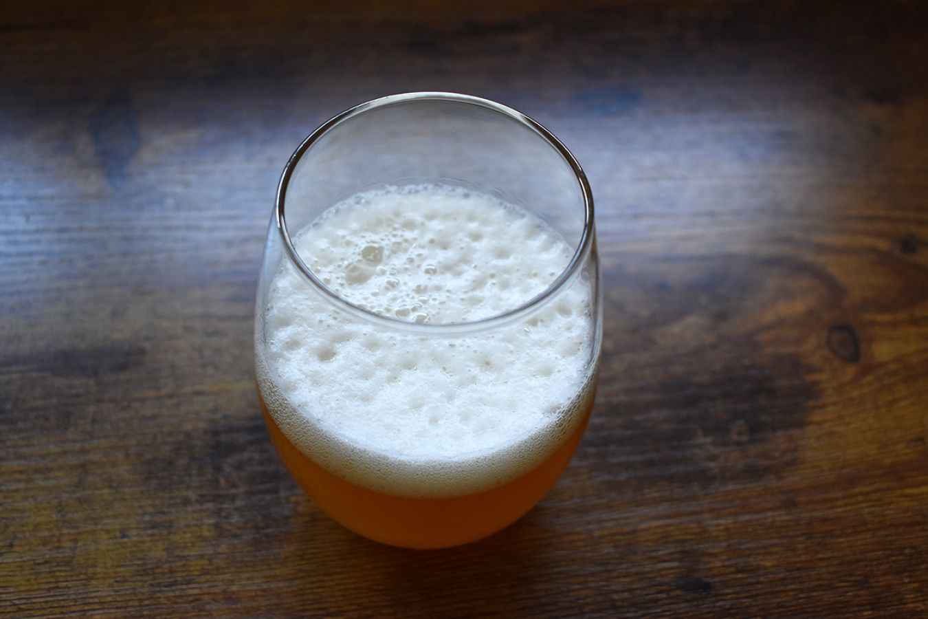 Photo of a small glass of a Milkshake IPA, shot from high angle so the focus is on the beers head; ©2022, Hollie Stephens Photography