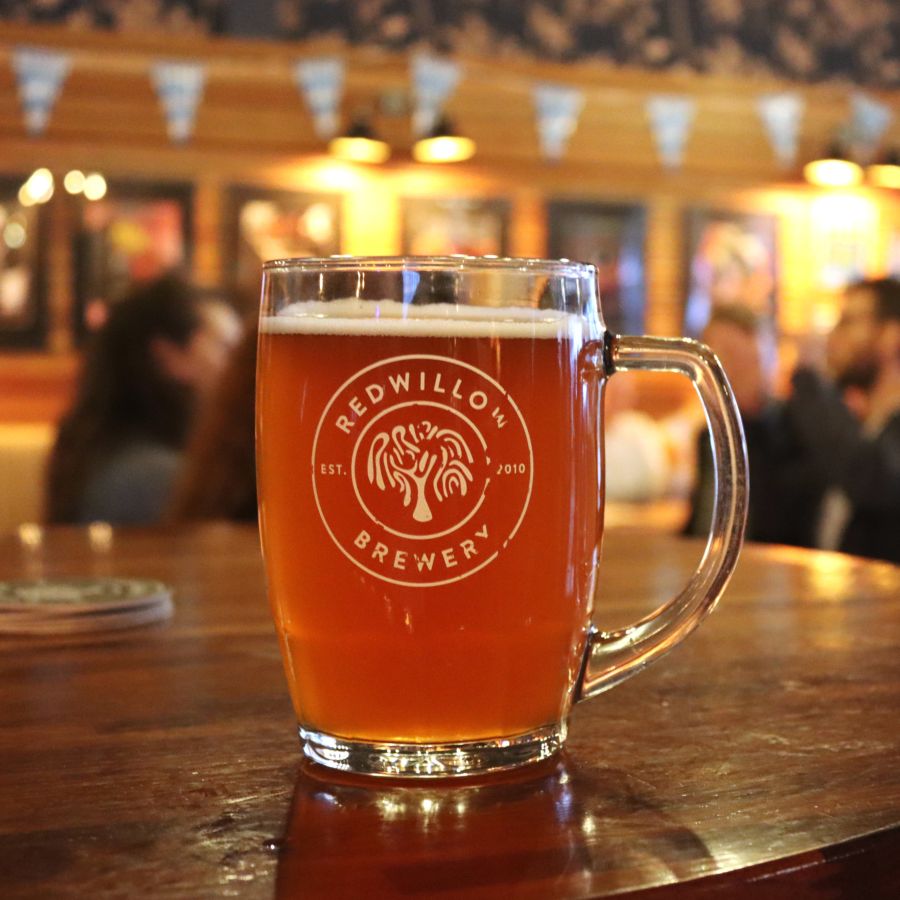 Photo of a pint of beer in a RedWillow branded pint glass