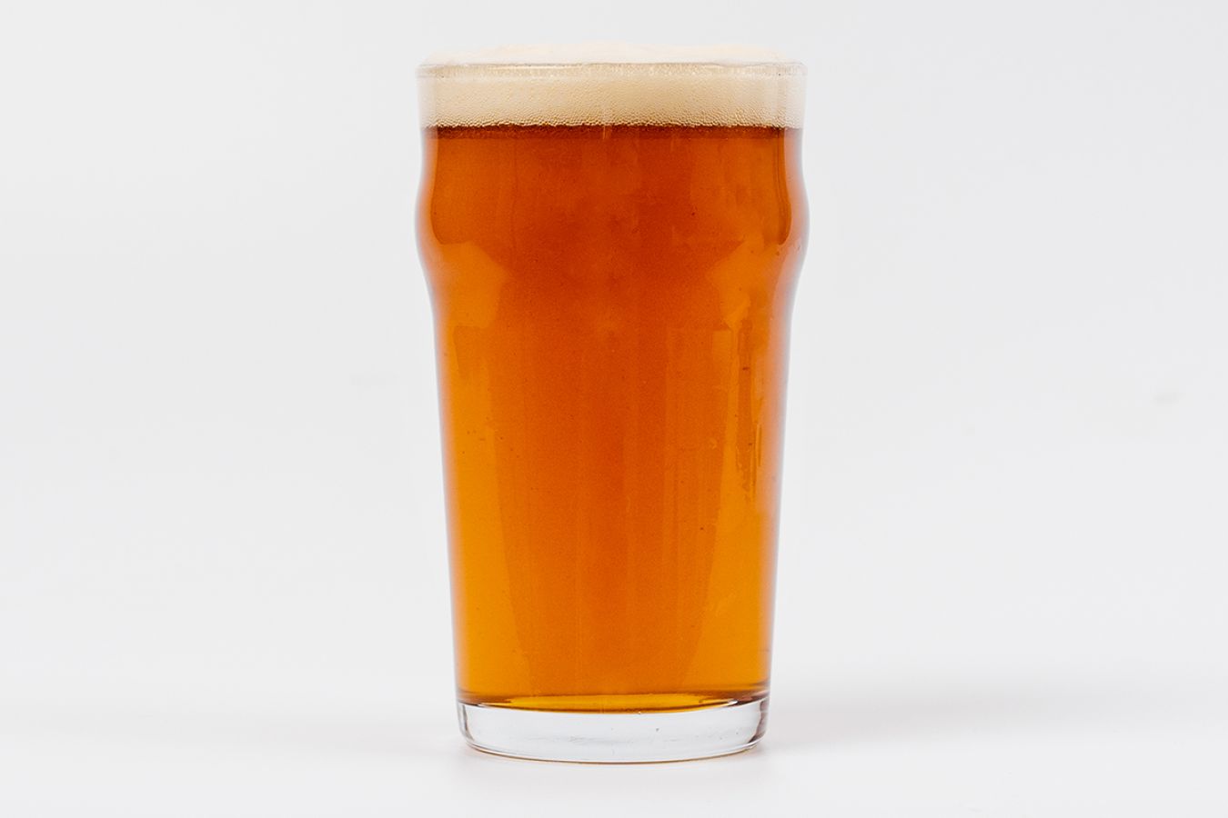 Pint of a British IPA - Worthingtons White Shield on a white background; ©2021, Nikki Peet Photography