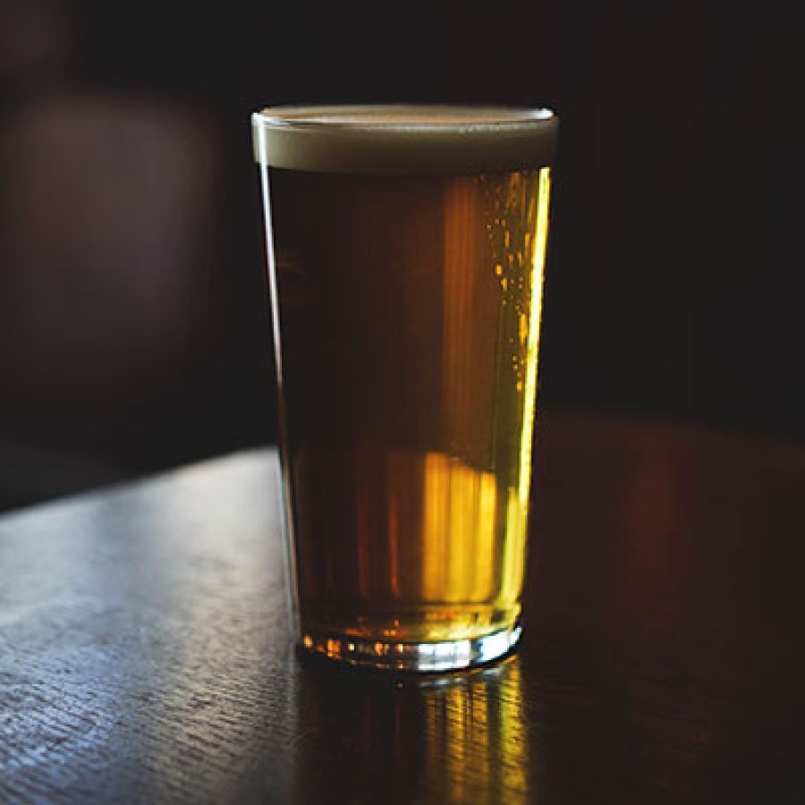 Photo of glass of Hazy Beer on wooden table; ©2021, Matthew Curtis Photography
