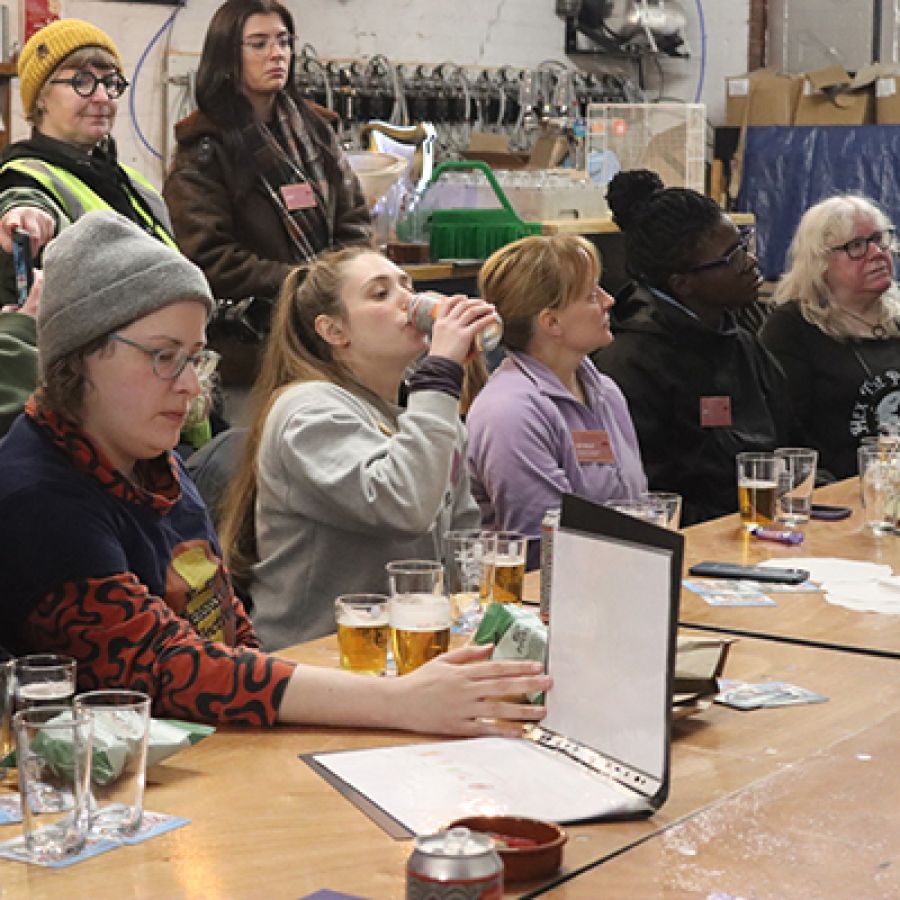 Photo of women gathered around a table at a IWCBD event © 2025, Laura Hadland Photography