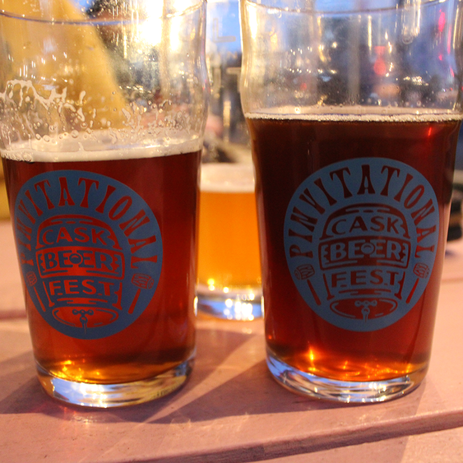 Close up of two pints of cask beer, with the pinvitational branding logo on the side © 2024, Justin Brummer