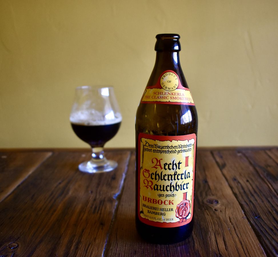 Photo of a bottle of braubier and a half a glass of braubier behind it out of focus. Taken by Hollie Stephens